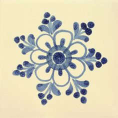 a blue and white snowflake is shown in the middle of this tile design