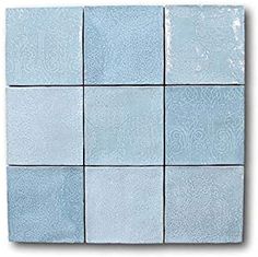 blue glass tiles with white and gray designs on the sides, all in different sizes