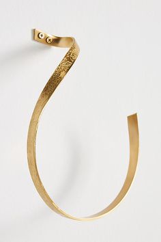 a close up of a gold bracelet on a white background