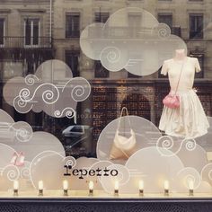 a window display with mannequins and bags in it