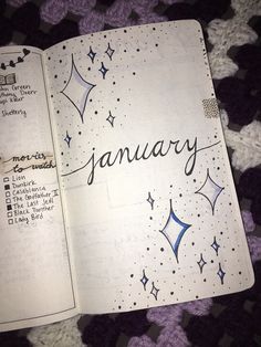 an open notebook with the word january written on it and stars in the sky above