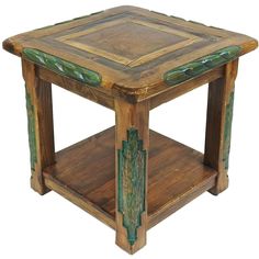 a small wooden table with green paint on it