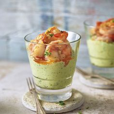 two small glasses filled with food on top of a table