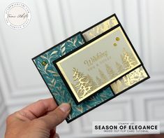 someone is holding up a card that has gold foil on it and the words season of elegance