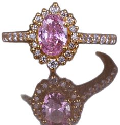 Luxury Pink Oval Cluster Ring, Pink Oval Diamond Ring With Center Stone, Pink Oval Cluster Ring With Center Stone, Pink Oval Diamond Ring With Accent Stones, Oval Pink Diamond Ring With Accent Stones, Pink Oval Cluster Ring Fine Jewelry, Luxury Pink Oval Halo Ring, Formal Pink Oval Halo Ring, Formal Oval Pink Halo Ring