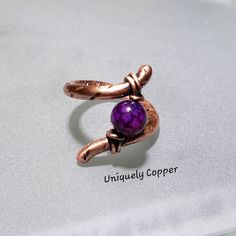 This gorgeous amethyst ring has been wire wrapped in copper, and then antiqued to highlight the beauty of the copper wire wrapping and the lovely February birthstone. It is ready to ship in a size 8 1/2 and is the perfect gift for her, for her February birthday, or 7th and 22nd Wedding Anniversaries, copper anniversary! NOTE: This copper ring is ready to ship in size 8 1/2. All other sizes of this amethyst ring are made to order in your exact size, simply select your ring size from the drop down Adjustable Purple Amethyst Ring, Adjustable Spiritual Purple Ring, Adjustable Purple Birthstone Ring For Anniversary, Unique Adjustable Amethyst Promise Ring, Hand Forged Adjustable Purple Jewelry, Adjustable Amethyst Crystal Wedding Ring, Adjustable Amethyst Crystal Ring For Anniversary, Adjustable Purple Amethyst Wedding Ring, Adjustable Purple Amethyst Ring For Wedding