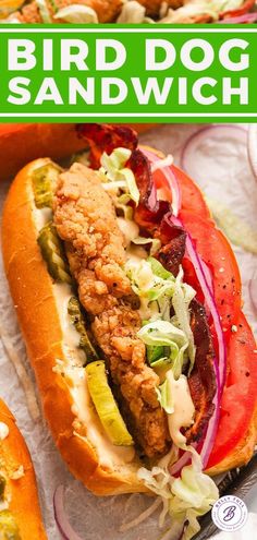 a sandwich with meat, lettuce and tomato on it is shown in front of the words bird dog sandwich