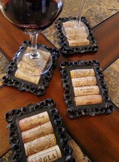 three wine cork coasters sitting on top of a table next to a glass of wine