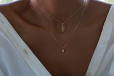 This necklace features a delicate 18K gold-filled tiny cross pendant and a dainty chain.  A beautiful and affordable alternative to solid gold. 18k Gold filled laminate is an excellent option for long-lasting pieces. High quality guaranteed (NO TARNISH).   D E T A I L S  * The cross pendant is removable from the chain * Cross measures  7mm x 12.5mm * Dainty 0.5 mm chain box  * Fine finish   18K  G O L D  F I L L E D   Our gold-filled chains are made with 5% of 18K gold (5 grams per kilo). Our 18K gold-filled jewelry is created with a thick layer of 18K solid gold over a metal core. The base material is brass (copper and zinc). They are hypoallergenic and nickel-free..  C H A I N  L E N G T H  Choose your favorite chain length and rock it! Available in 14", 16",18", or 20".  Please note: a Minimalist Cross Necklace, Dainty Cross Necklace, Tiny Cross, Dainty Chain, D F, Gold Necklace Layered, Chain Gold, Layering Necklace, Necklace Dainty