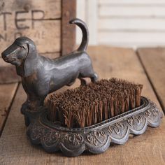 a dog brush sitting on top of a wooden table