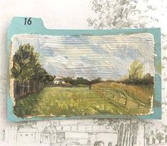 a drawing of a field with trees and buildings in the background, on top of a piece of paper