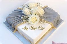 a white and blue cake with flowers on it that says, happy anniversary any name here