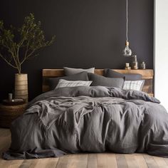 A grey bedroom with wooden floors and an Ebb & Weave Graphite Grey Luxury Cotton Bedding Set. Dark Bedding Sets, Dark Sheets Bedding, Grey Duvet Cover Bedroom, Brown Grey Bedroom, Mens Small Bedroom, Grey Sheets Bedroom, Black And Grey Room, Grey Bed Decor, Charcoal Grey Bedroom