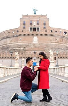 a man kneeling down next to a woman