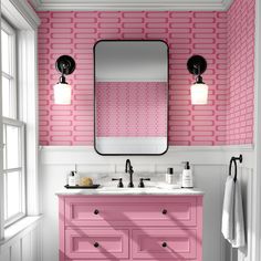 a bathroom with pink and white walls, two sinks and a large mirror on the wall