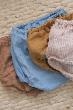 three baby bloomers sitting on top of a bed with the words, sewing for babies