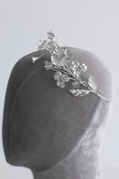 Crown with crystals Crystal crown Description: The floral silver tiara presents flowers and glistening crystals. An ideal choice to finalize your bridal look, this tiara adds the perfect finishing touch to your ensemble. Details: Handcrafted leaf and floral design Sparkling crystals Сomposition: SilverCopperCrystals Silver Flower Crown, Wedding Dress Coat, Wildflower Crown, Silk Bridal Gown, Silver Tiara, Silk Wedding Dress, Silver Crown, Crystal Crown, Wedding Tiara