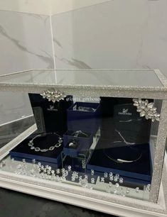 a glass display case with jewelry in it