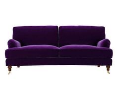 a purple couch sitting on top of a white floor