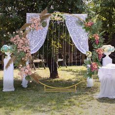 an outdoor wedding setup with flowers and greenery