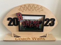 a wooden frame with the number twenty eight on it and a football team photo inside