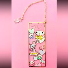 a cell phone case with an animal and hearts design on the back, hanging from a gold chain