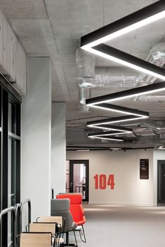 an empty room with chairs and tables in it