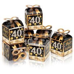 four black and gold gift boxes with golden ribbons on the top, one for forty