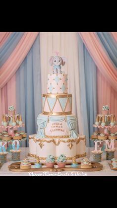 there is a cake with an elephant on top and many other decorations around the cake