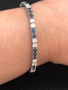 Set your eyes on this gorgeous and elegant vintage platinum cornflower blue sapphire and diamond tennis bracelet. The cornflower blue sapphires weigh approximately 5 carats. The diamonds weigh approximately 3 carats. The diamonds are VS-SI clarity and G-H color. This piece, circa 1950s, weighs 12.11 grams and is 7 inches long. Platinum Jewelry With Blue Single Cut Diamonds, Blue Single Cut Diamond Jewelry In Platinum, Blue Platinum Jewelry With Single Cut Diamonds, Blue Diamond Platinum Bracelet For Formal Occasions, Formal Blue Diamond Platinum Bracelet, Formal Blue Platinum Bracelet, Classic Sapphire Diamond Bracelet With Brilliant Cut, Classic Blue Round Tennis Bracelet, Classic Sapphire Tennis Bracelet With Brilliant Cut