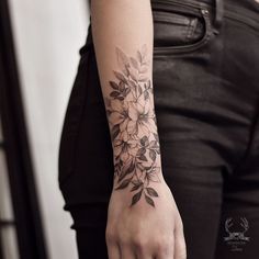 a woman with a flower tattoo on her arm