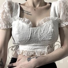 This Darling Crop Top Is The Epitome Of Sweet And Flirty Cottage Core Style. Featuring Delicate Eyelet Fabric And Dainty Lace Trim Detailing, And Bustier Style With Adjustable Lace Up Sides And Puffy Lace Sleeves, This All White Top Exudes A Charming, Fairycore Vibe. The Back Zip Closure Adds A Touch Of Practicality To This Whimsical Piece, Perfect For Adding A Romantic Touch To Any Outfit. New Without Tags. Measurements Included In Listing Pictures To Ensure Fit. From Both A Pet Free And Smoke Spring Cottagecore Lace Top, White Fitted Cottagecore Top, Cute Ruffled Crop Top, Cute Fitted Ruffle Crop Top, White Fitted Cute Blouse, Cute Fitted White Blouse, Fitted Summer Tops With Lace Trim, White Cottagecore Blouse For Summer, Fitted Lace Trim Top For Summer