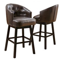 two brown leather bar stools sitting next to each other