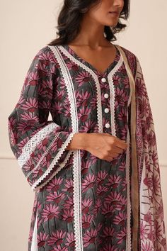 This is a Grey Hand Block Printed Kurta with broad V neckline and with lace work detailing. It is paired with beautiful white palazzo detailed with lace work and with Chanderi Dupatta. Model height is 5.8 feet and is wearing size S Wash Care Handwash lightly with mild detergent. Do not soak. Dry inside out in shade. Important All our suit sets come with sufficient alterable margins. Laces Designs On Printed Suits, Lace Pattern Suits, Cotton Palazzo Suit Designs, Kurta With Lace Pattern, Broad V Neck Kurti Design, Kurti Design With Lace Work, Lace Work Suit Design Pakistani, Simple Suit With Lace Design, White Lace Neck Design Kurti