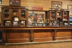 a wooden bar with lots of bottles on it