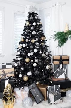 a black and white christmas tree surrounded by presents