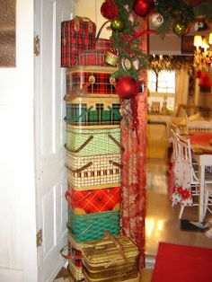 christmas presents are stacked on top of each other in front of an open door,