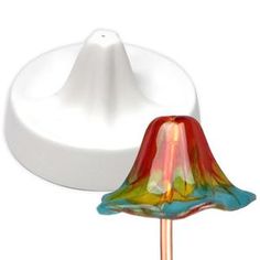 a colorful glass lamp sitting on top of a white table