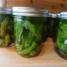 several jars filled with pickled green beans