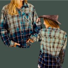 two women wearing plaid shirts and hats, one is holding the other's hand