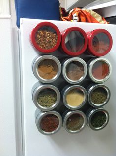 a refrigerator filled with lots of different types of spices on top of it's doors