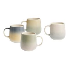 four coffee mugs sitting next to each other