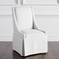 a white chair sitting on top of a hard wood floor