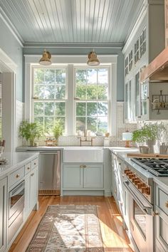 a kitchen with blue walls and white cabinets, an area rug in front of the stove