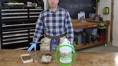 a man standing in front of a blackboard with writing on it and cleaning supplies