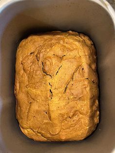 a loaf of bread in a metal bowl