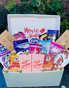 a box filled with snacks and movie tickets