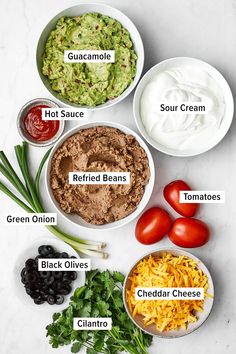 the ingredients for guacamole dip in bowls on a white counter top with text overlay