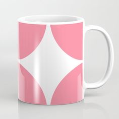 a pink and white coffee mug with an abstract design