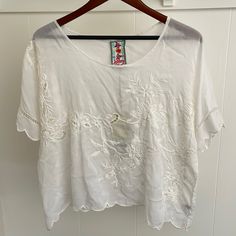 Beautiful Light Weight Johnny Was Embroidered Short Sleeve Blouse, Women’s Size Small. Fit Is Relaxed. New With Tags. Off White With Matching Flower Embroidery. Small Signs Of Damage On The Back Left Shoulder (Please See Pictures, Price Reflects This). White Bohemian Top With Tonal Embroidery, White Bohemian Tops With Tonal Embroidery, White Cotton Embroidered Top With Tonal Embroidery, White Short Sleeve Tops With Tonal Embroidery, Short Sleeve Cotton Top With Tonal Embroidery, Casual Short Sleeve Embroidered Top With Tonal Embroidery, Casual Short Sleeve Embroidered Top With Tonal Details, Short Sleeve Cotton Embroidered Top With Tonal Embroidery, White Short Sleeve Top With Cutwork Hem